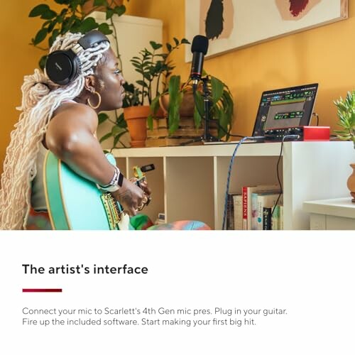 Artist setting up home recording studio with headphones and guitar.