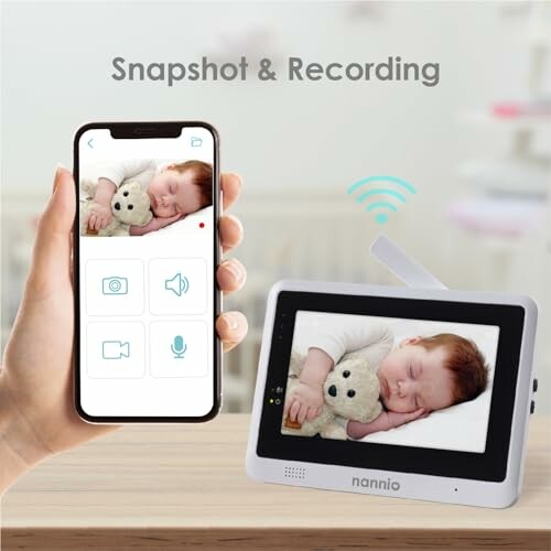 Smartphone and baby monitor displaying sleeping baby. 