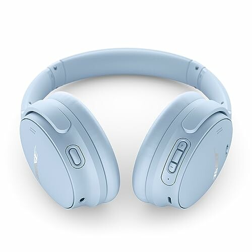 Light blue wireless headphones with buttons on the side