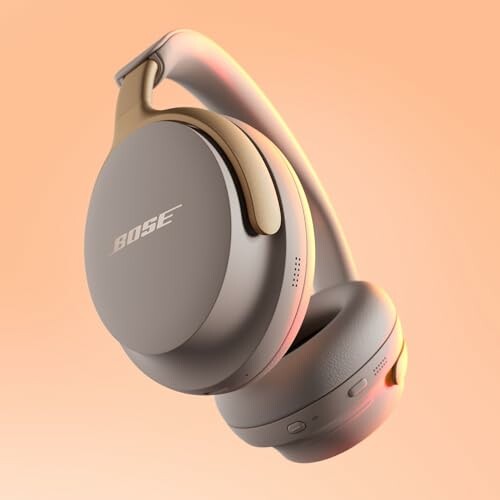Bose wireless headphones on peach background.