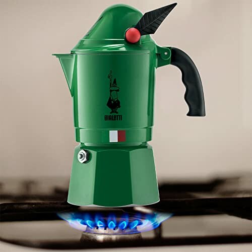 Green Bialetti espresso maker on gas stove