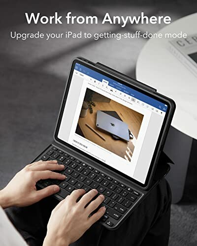 Person using an iPad with a keyboard attachment, displaying a document.
