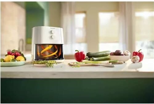 Kitchen counter with a food processor and assorted fresh vegetables.
