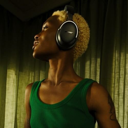 Person wearing headphones and a green top