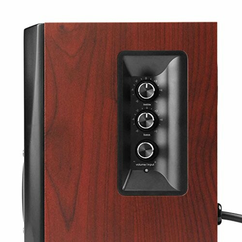 Side view of a speaker with wooden panel and control knobs.