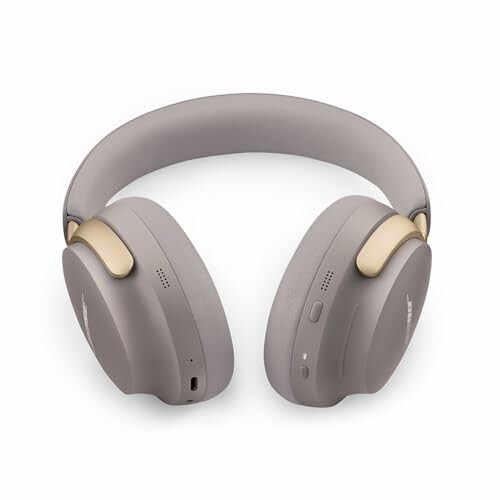Grey wireless headphones with gold accents.